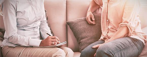 Therapist chatting with client on a couch in Brixton